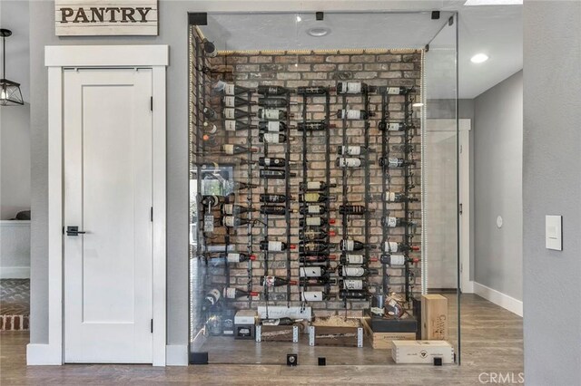 wine room featuring baseboards and wood finished floors