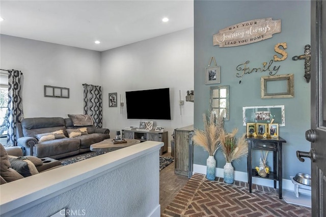 living room with recessed lighting, brick floor, and baseboards