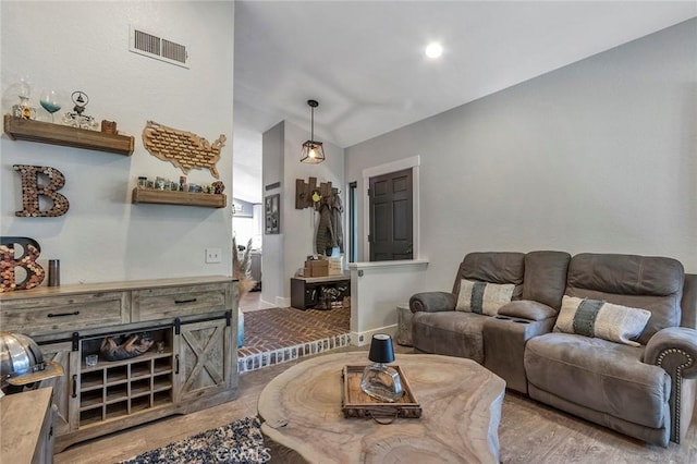 living room with wood finished floors and visible vents