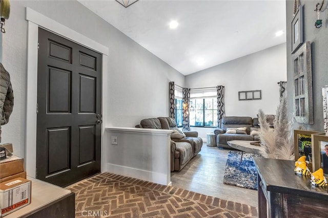 living room featuring brick floor, baseboards, lofted ceiling, and recessed lighting