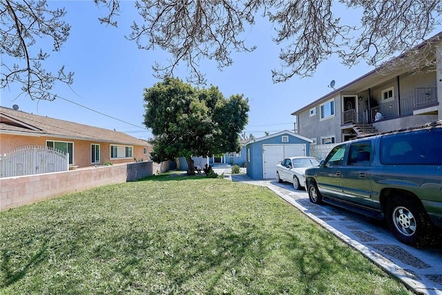 view of yard featuring an outbuilding and fence