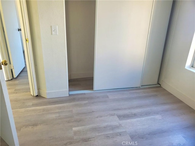 interior space featuring baseboards and wood finished floors