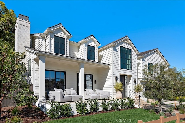 view of front of property featuring an outdoor hangout area and a chimney