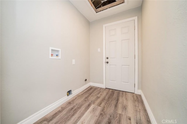 washroom featuring laundry area, light wood-type flooring, baseboards, and washer hookup