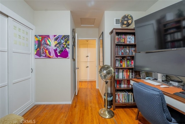 home office featuring attic access, wood finished floors, visible vents, and baseboards