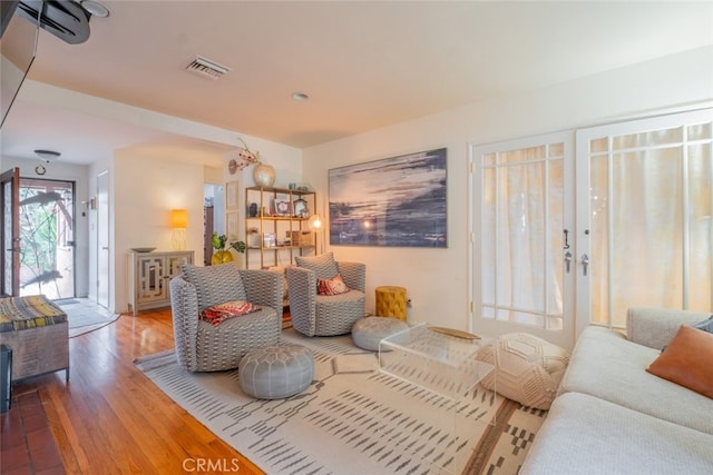 living room with wood finished floors and visible vents