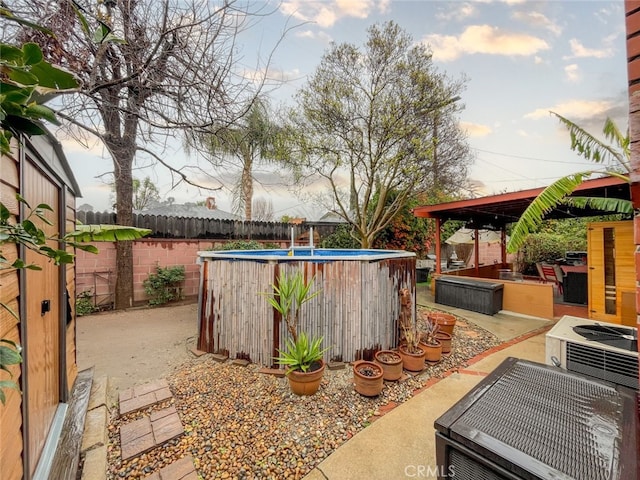 view of yard featuring a fenced in pool, a fenced backyard, and a patio area