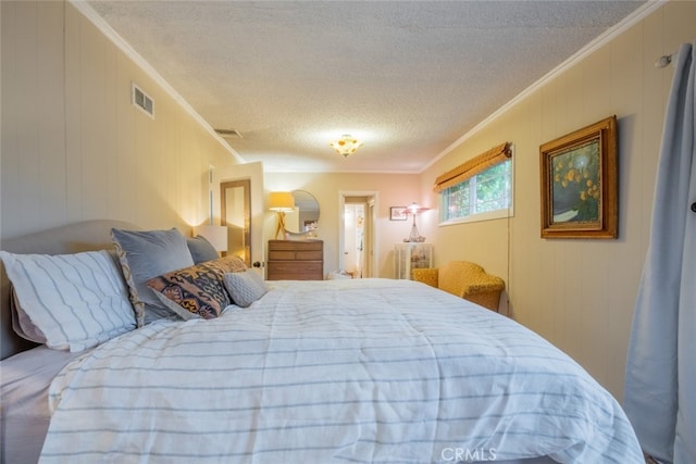 bedroom featuring visible vents, a textured ceiling, and ornamental molding