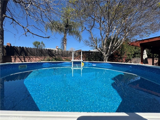 view of pool featuring a fenced backyard and a fenced in pool