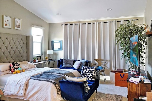 bedroom with lofted ceiling and carpet floors