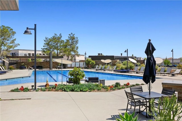 community pool featuring a patio area and fence