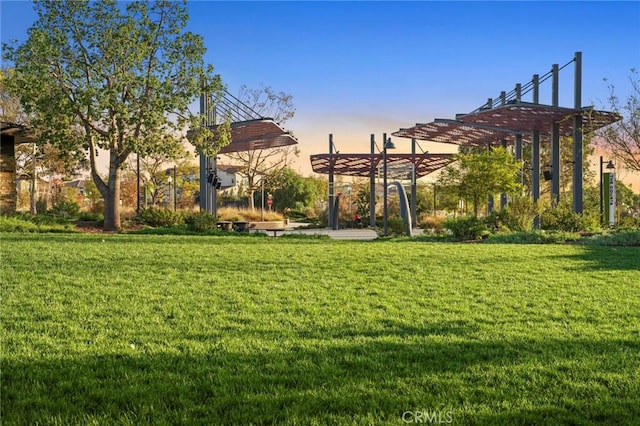 view of community with a yard and a pergola