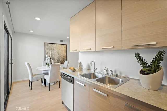 kitchen with dishwasher, light countertops, and modern cabinets