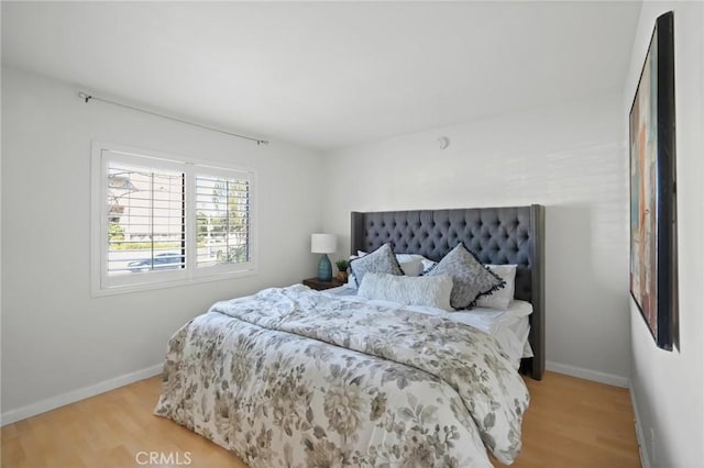 bedroom with baseboards and light wood-style floors