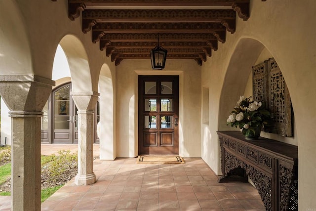 doorway to property featuring stucco siding