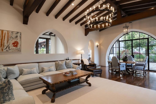 living area featuring plenty of natural light, high vaulted ceiling, and wood finished floors