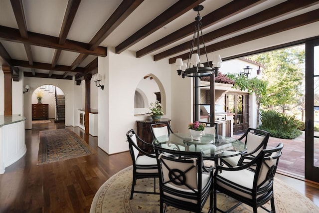 dining room with beamed ceiling, french doors, an inviting chandelier, wood finished floors, and arched walkways