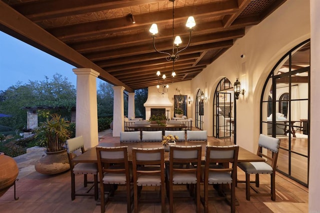 view of patio featuring exterior fireplace and outdoor dining space