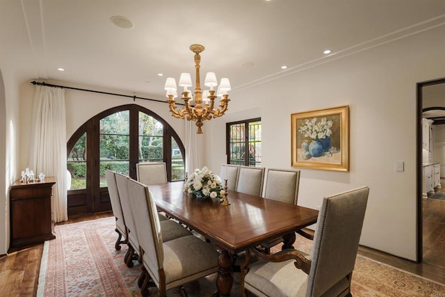 dining room with a chandelier, recessed lighting, crown molding, and wood finished floors