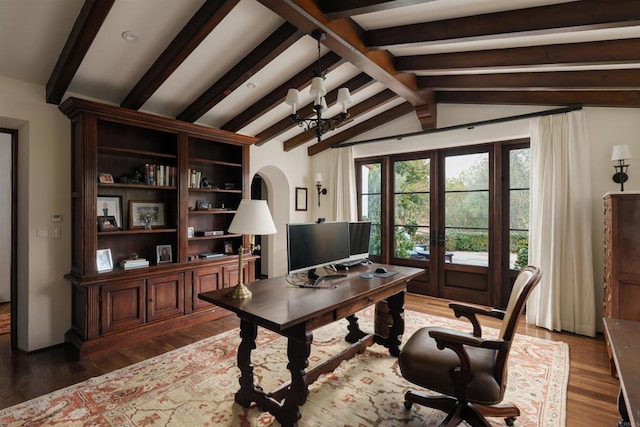 home office with a chandelier, lofted ceiling with beams, french doors, wood finished floors, and arched walkways