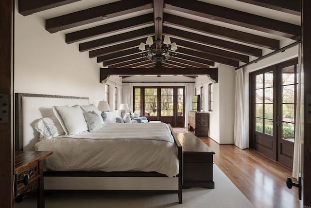 bedroom with access to exterior, a chandelier, lofted ceiling with beams, french doors, and wood finished floors