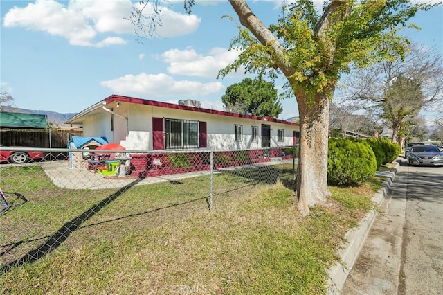 ranch-style house with stucco siding, a front yard, and fence