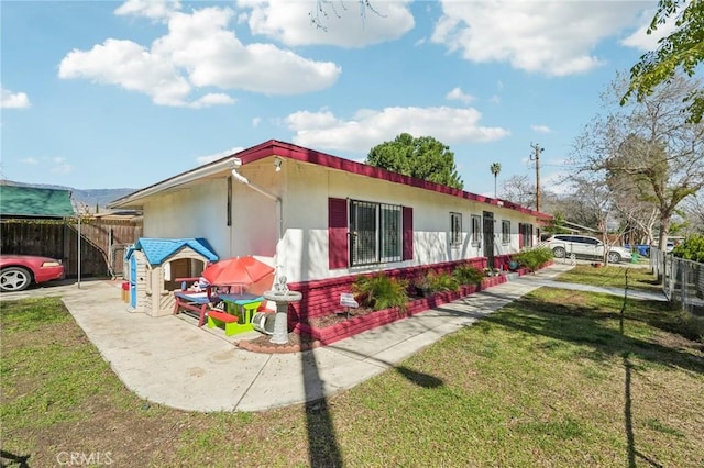 view of side of property with a yard and fence