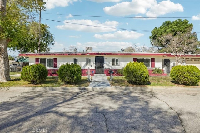 single story home featuring a gate and a fenced front yard