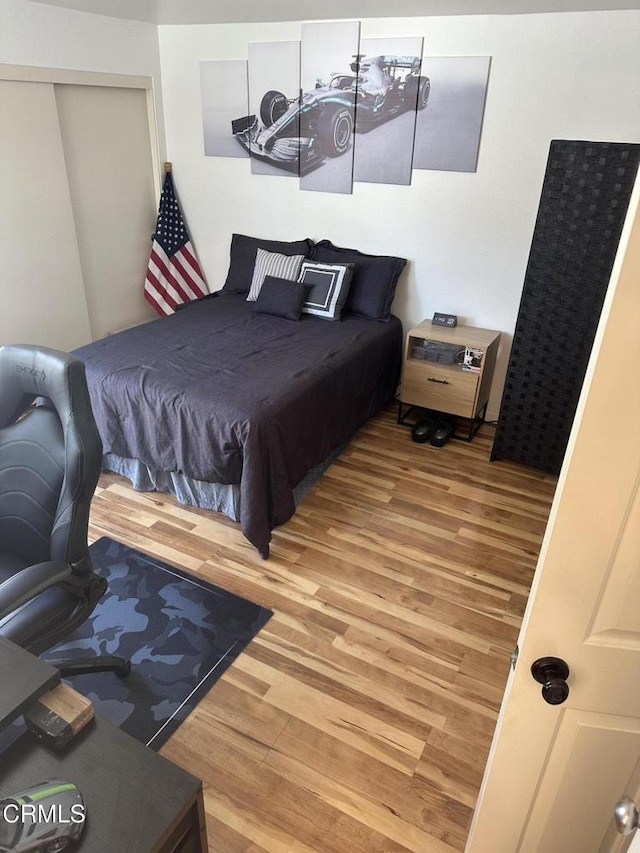 bedroom featuring a closet and wood finished floors