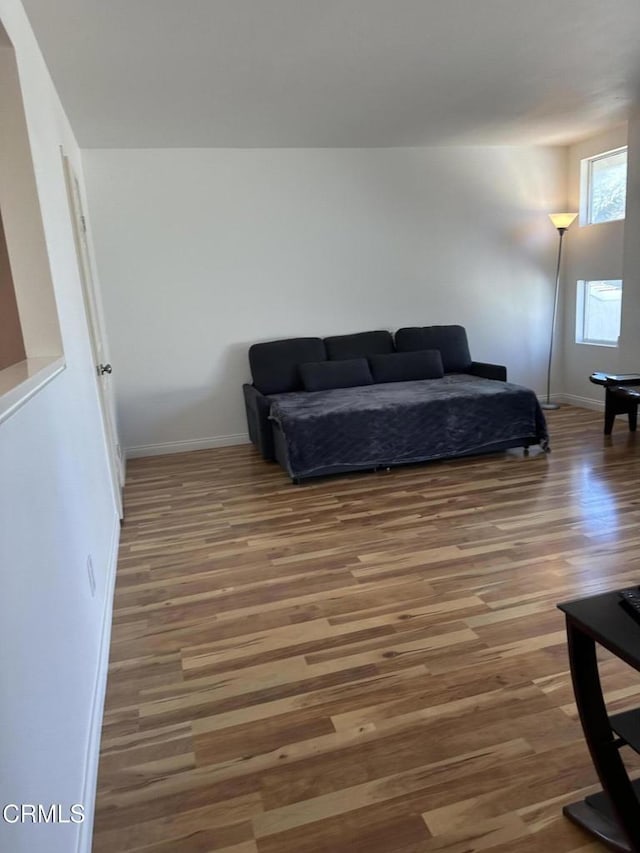 interior space with wood finished floors and baseboards