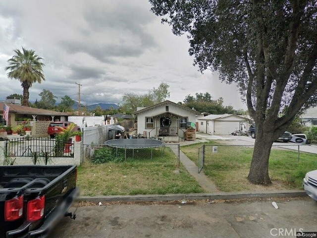 view of front of house with a front yard, a garage, and a fenced front yard