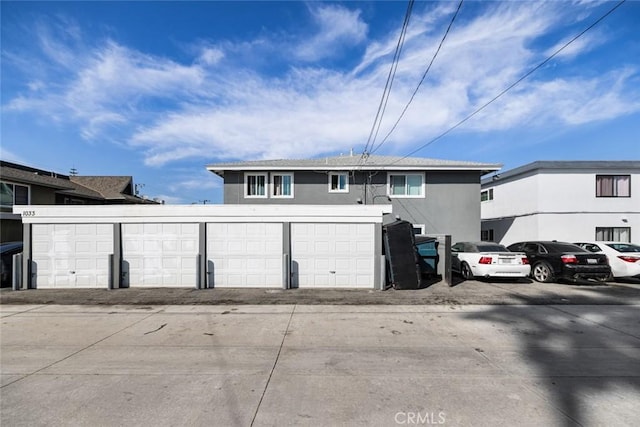 view of front of home with a garage and stucco siding