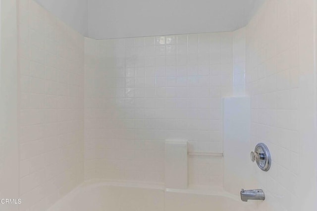 interior details featuring shower / bathing tub combination