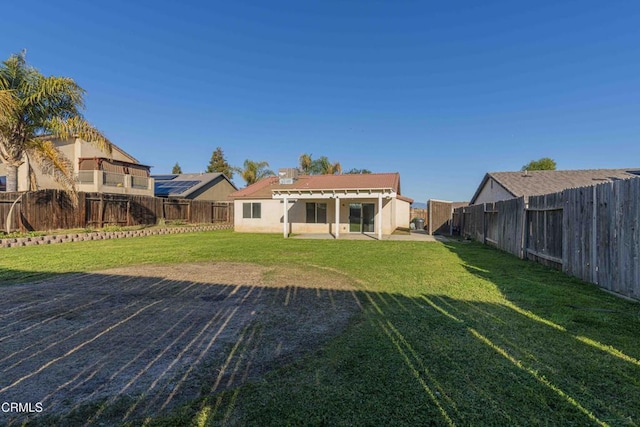 back of house featuring a fenced backyard and a lawn