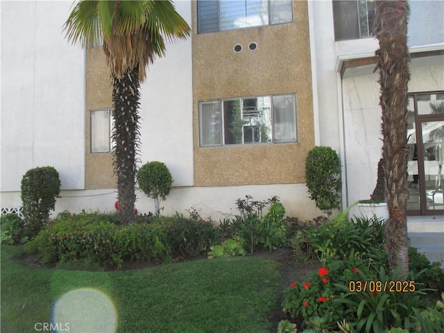 view of home's exterior featuring a lawn and stucco siding