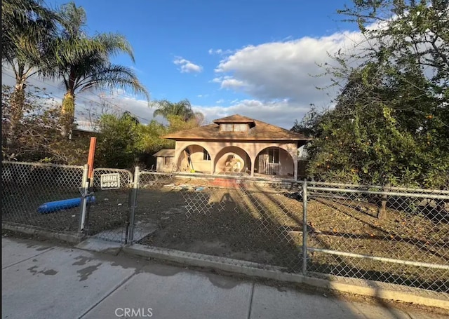 view of gate with a fenced front yard