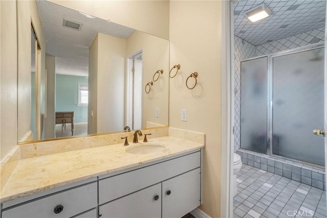 bathroom featuring visible vents, baseboards, toilet, and vanity