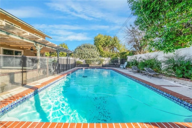 view of pool with a fenced in pool, a patio, a fenced backyard, and a ceiling fan