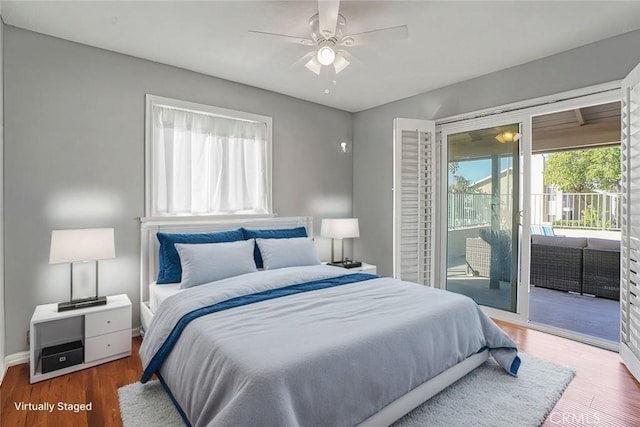 bedroom featuring a ceiling fan, access to outside, wood finished floors, and baseboards