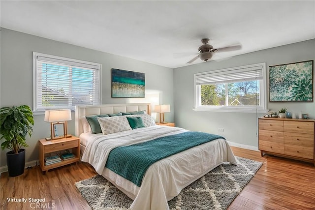 bedroom featuring a ceiling fan, wood finished floors, and baseboards