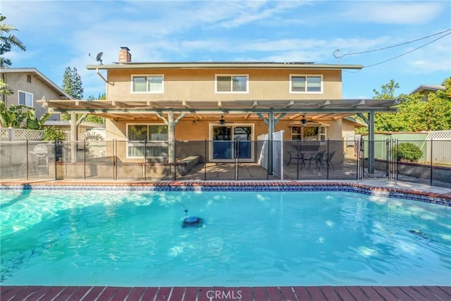 view of swimming pool with a fenced in pool, ceiling fan, a patio, and fence