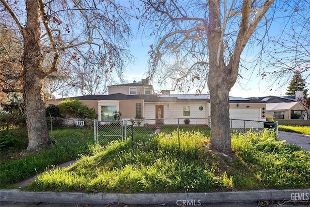 view of front of house featuring a fenced front yard and a garage