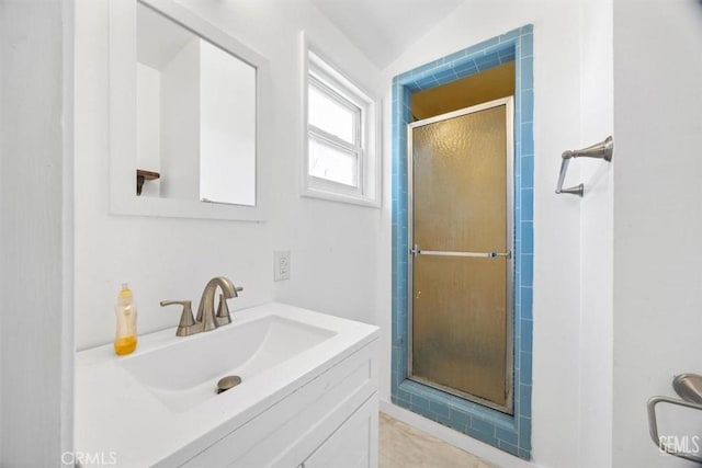 full bath with vanity, a shower stall, and tile patterned flooring