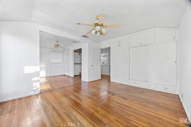 interior space with light wood finished floors, visible vents, baseboards, and ceiling fan