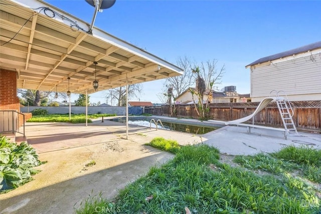 exterior space with a patio, a fenced backyard, and a carport