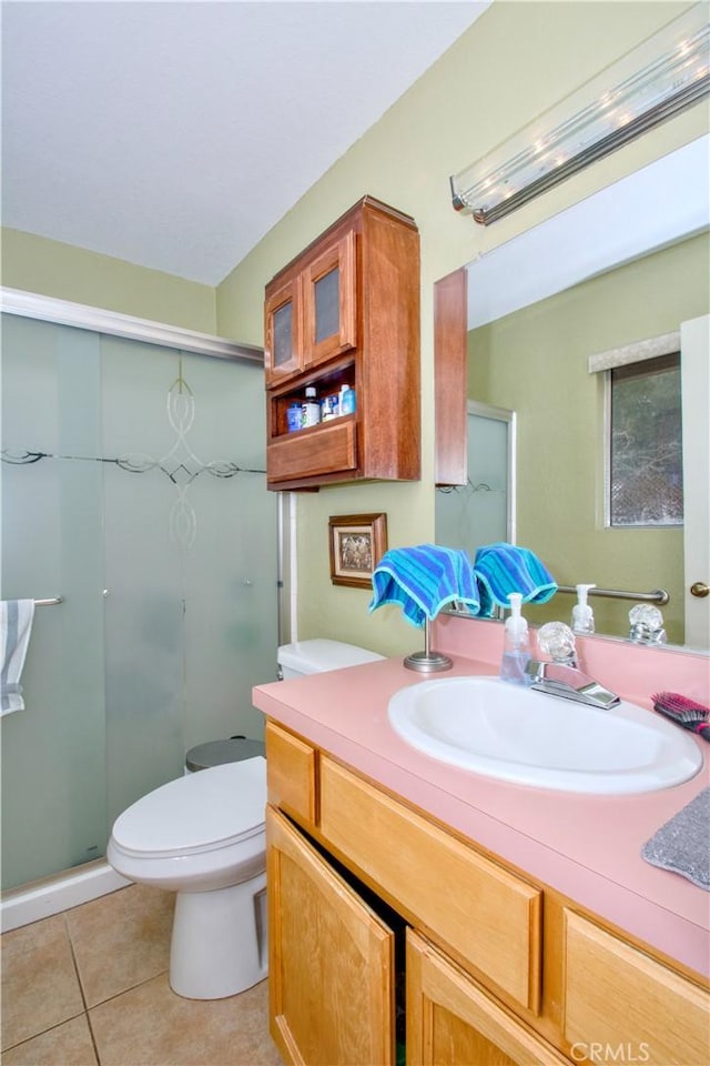 full bathroom with tile patterned flooring, a shower stall, vanity, and toilet