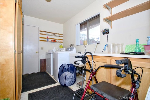 workout area featuring tile patterned floors and washing machine and clothes dryer