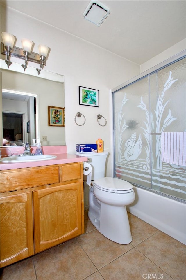 bathroom with visible vents, bath / shower combo with glass door, toilet, tile patterned floors, and vanity