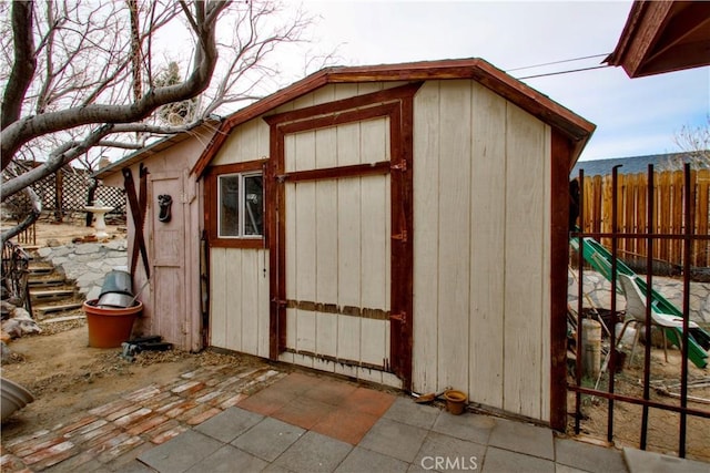 view of shed featuring fence