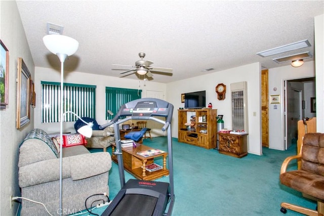 living room featuring visible vents, a textured ceiling, a ceiling fan, and carpet